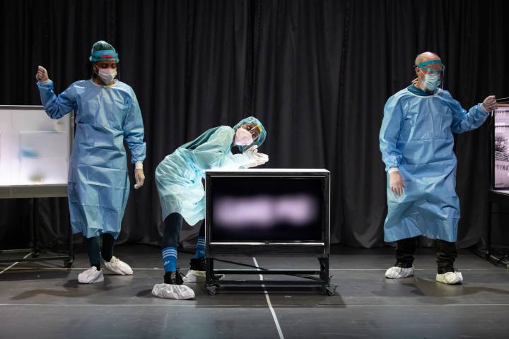 actors dressed in hospital scrubs on stage